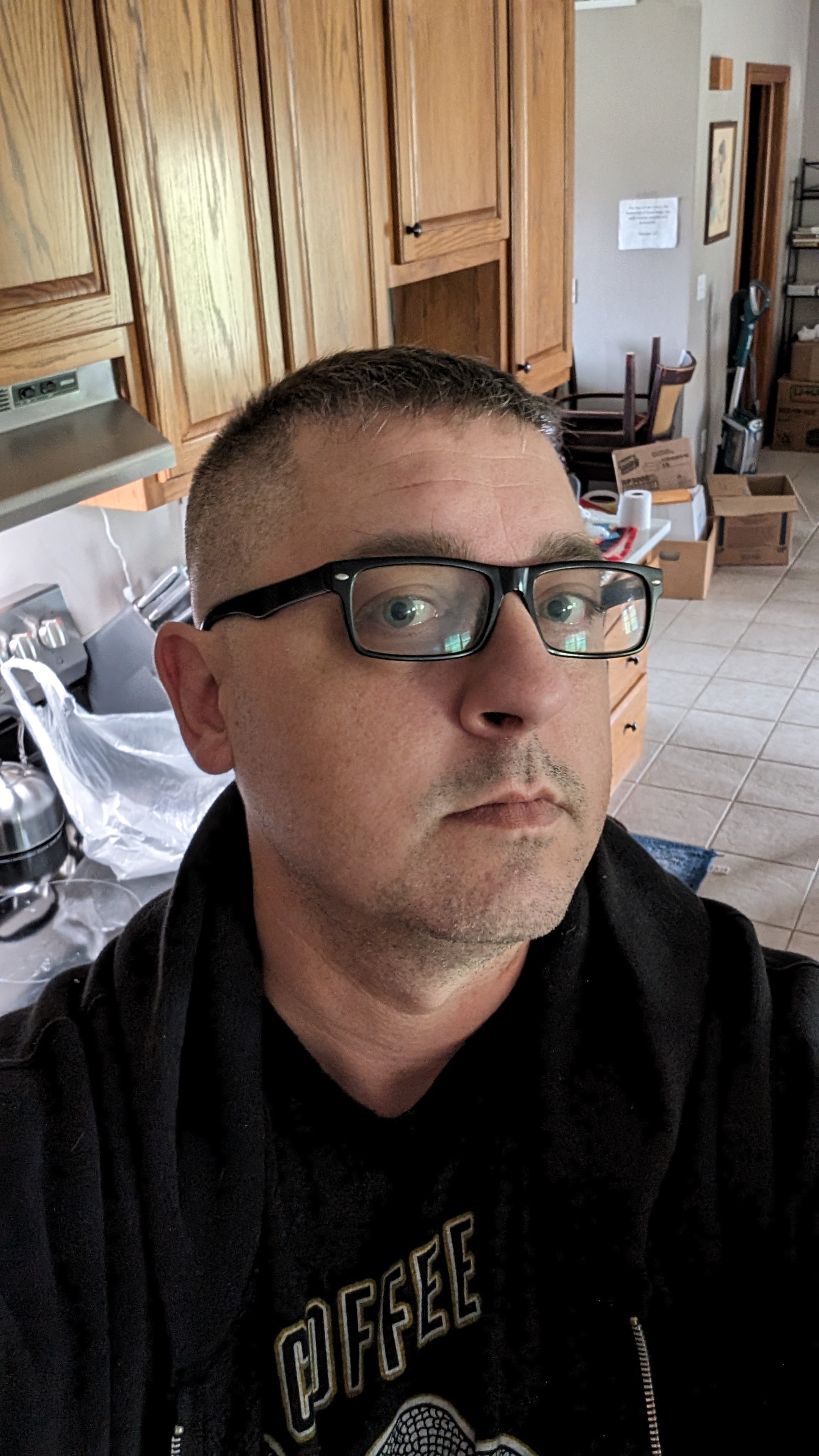 Photo of Chad indoors wearing glasses and a dark hoodie